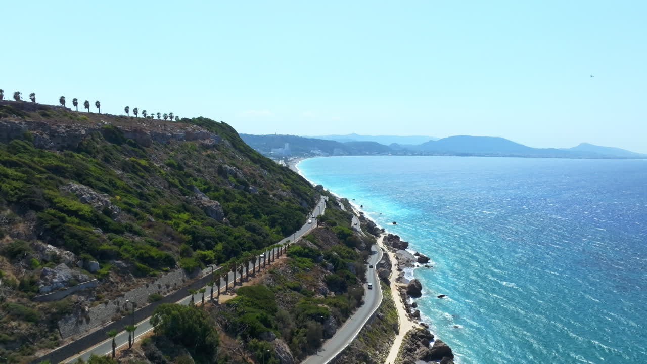 Drone tilting along the shoreline of the Rhodes island, sunny day in Greece