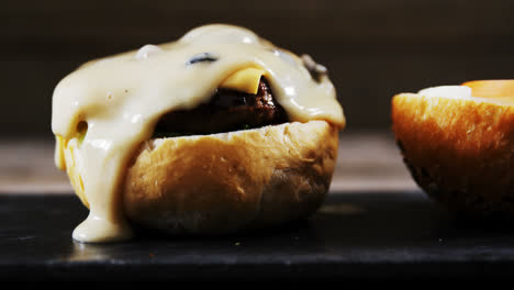 melted cheese over hamburger on tray