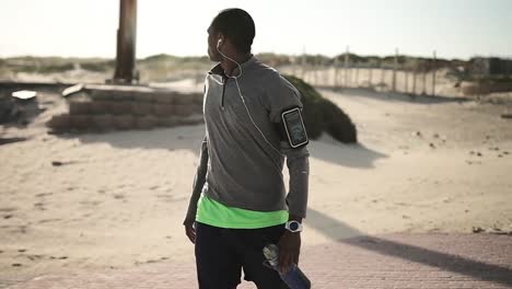 man with water bottle standing on the street