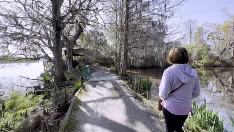 woman-walks-down-trail-in-low-country-near-charleston-sc,-south-carolina