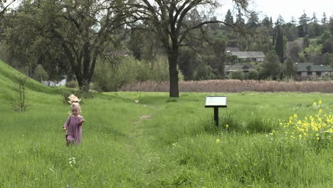 a girl walking through a restored wetlands at the ojai meadow preserve in ojai california