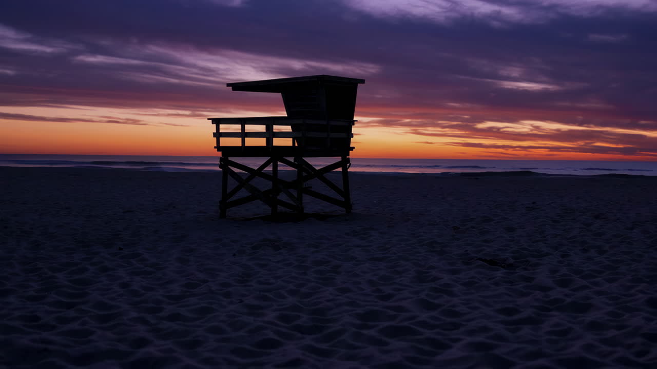 Vibrant Sunset Sky Over a Lifeguard Stand on the Beach