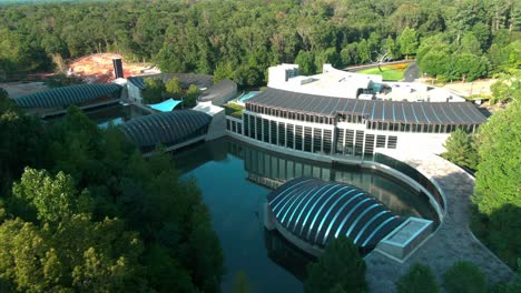 low drone shot of crystal bridges over a small lake