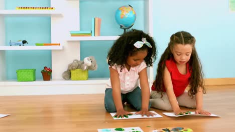 Kids-finger-painting-on-sheets-of-paper