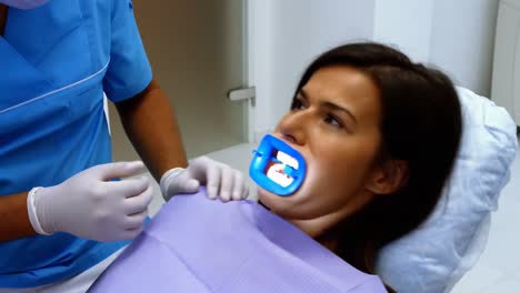 Dentist-interacting-with-female-patient