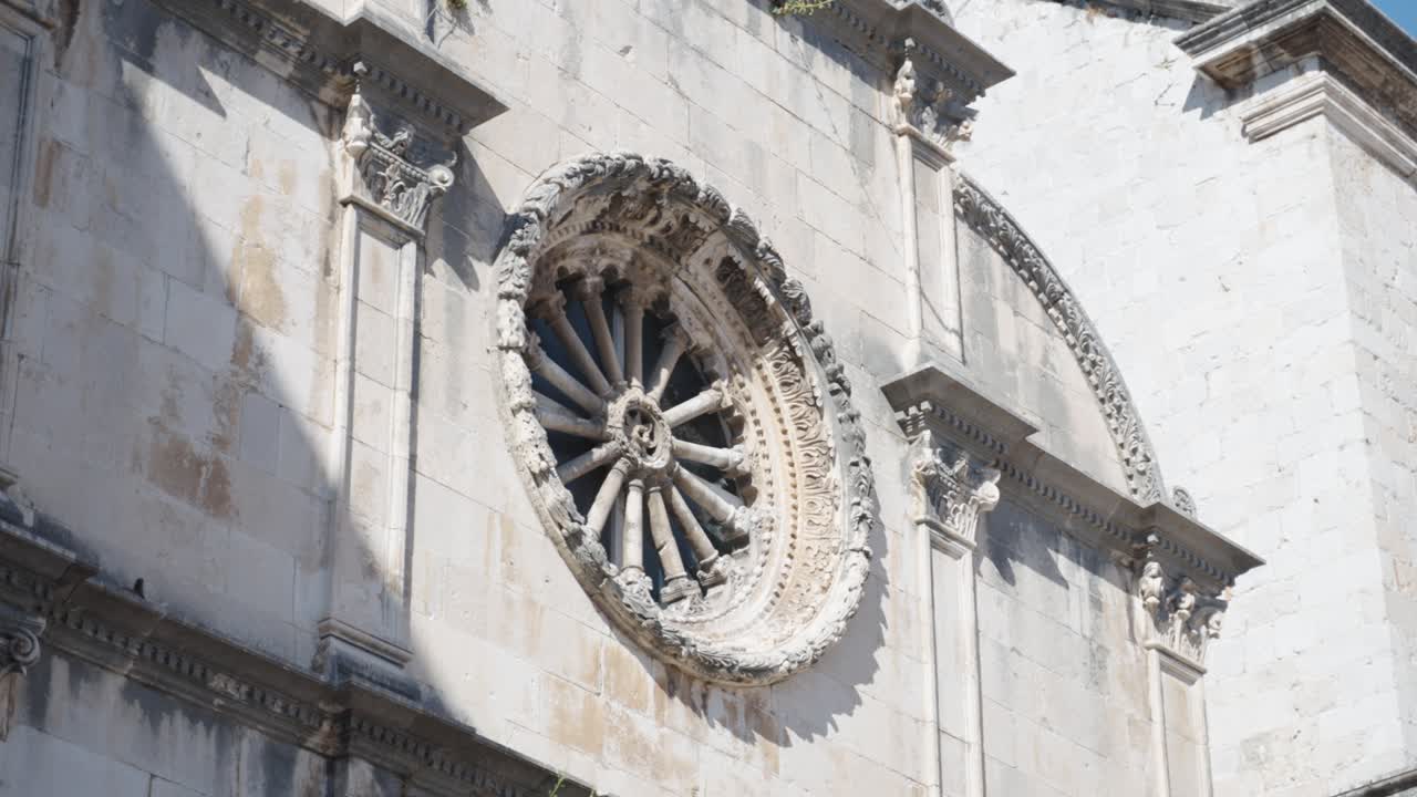 Close up on a large beutiful renaissance style window of the Franciscan Monastery Museum in Old Town of Dubrovnik Croatia near the entrance gate Pile on a bright summer day
