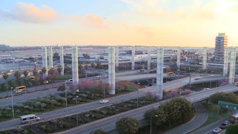 Zoom-back-from-cars-arriving-at-LAX-to-airport-establish