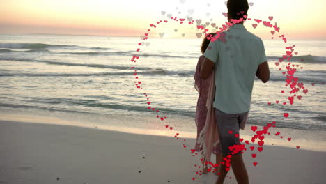 animation of hearts moving over diverse couple in love dancing on beach in summer