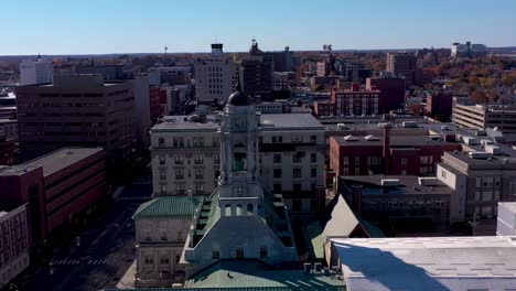 drone orbiting the steeple of city hall in portland, maine with the city in the background