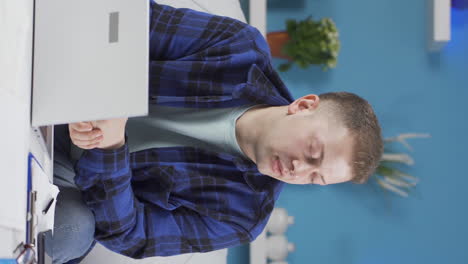 Vertical-video-of-Home-office-worker-man-looking-at-camera-with-disgust-and-hatred.