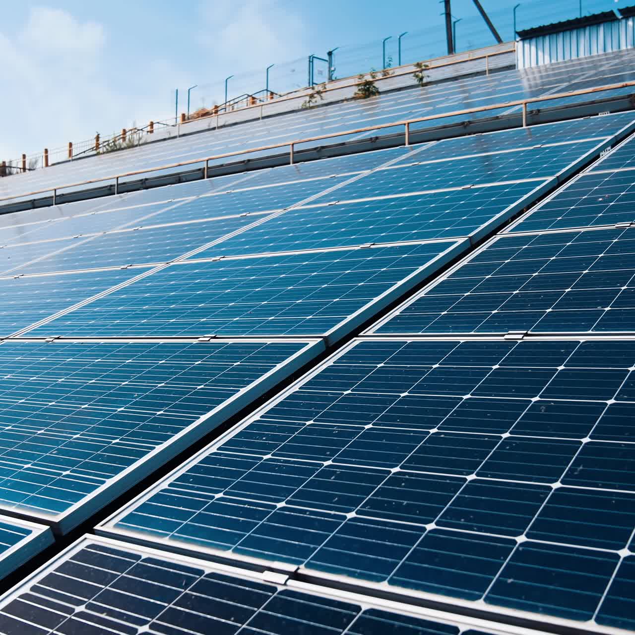 Photovoltaic panels at sunlight. Modern solar farm with blue sunny batteries. Renewable source of clean energy. Innovative electricity station