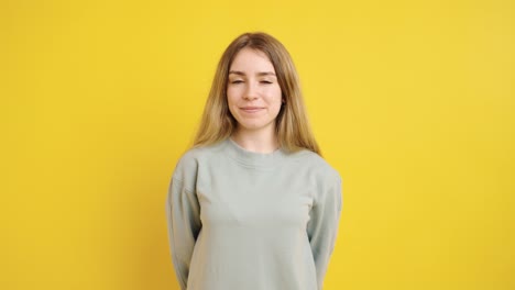 smiling woman offering gift box against yellow background