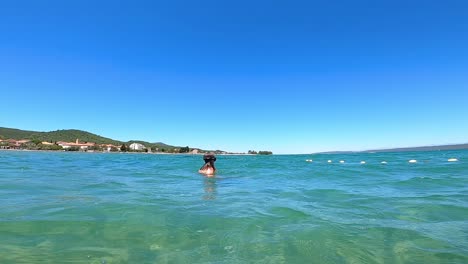 female caucasian holiday tourist playing underwater, slow motion