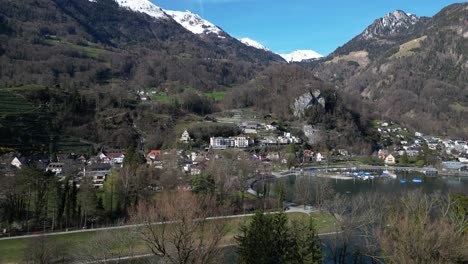 panning drone clip showing traditional swiss lakeside village in the alps