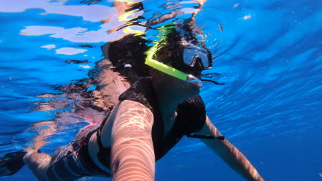 snorkeling experience enjoying in deep blue sea with snorkeling gears | tourist enjoying snorkeling and filming himself underwater video background | selfie video underwater of tourist snorkeling