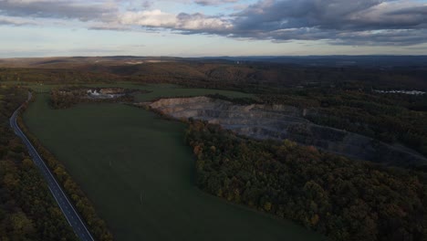 drone 4k shot of a quarry in fields during autumn sunset with colorful leaves