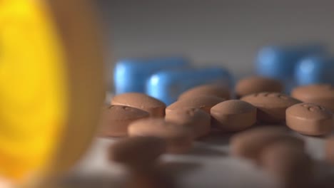 handful of brown pills on top of a white table with blurry background - closeup shot