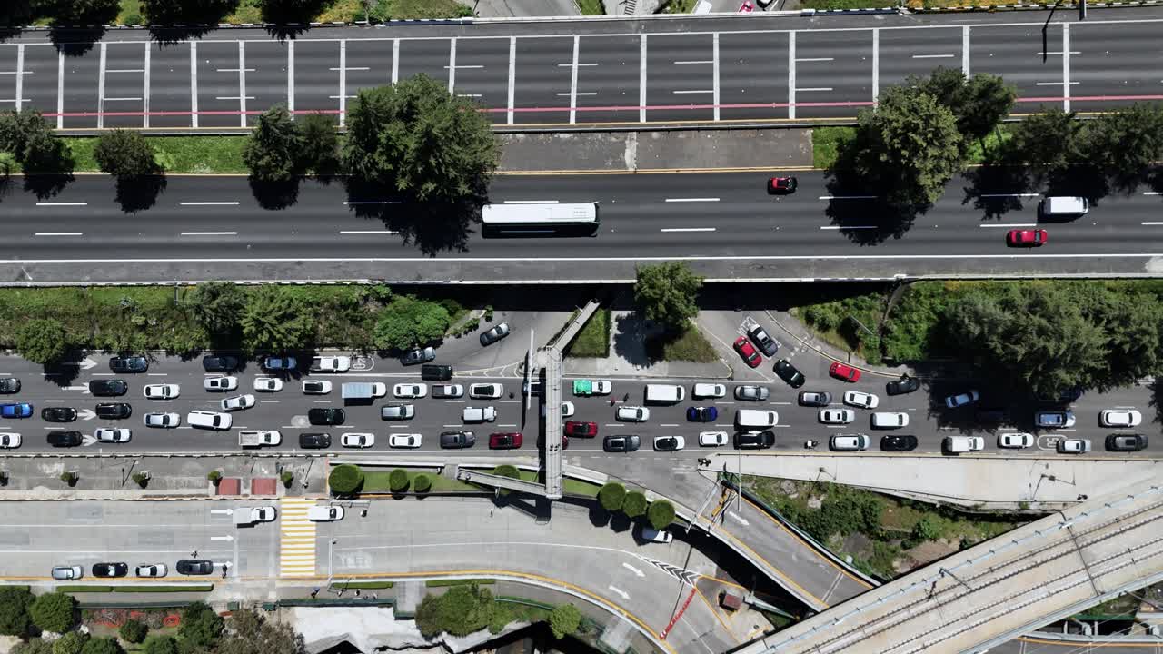 Close-up drone footage of cars stuck in traffic on a Mexico City street