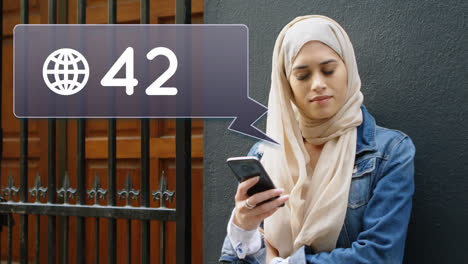 woman leaning on a wall while texting for social media