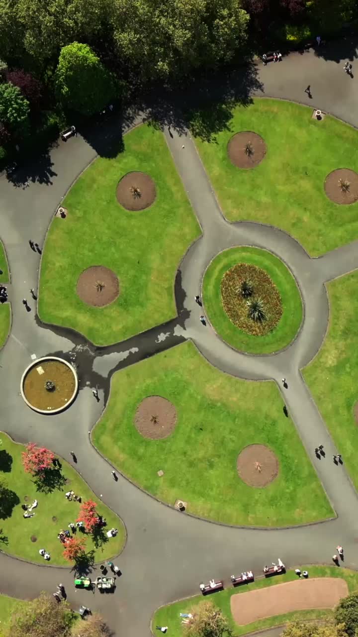 Social ratio aerial video of the grounds of St Stephen's Green in Dublin City Centre, Ireland on a bright and sunny day. Filmed in 1080x1920 and with Rec709 color