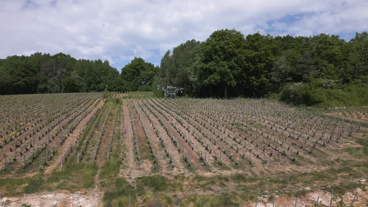 Farming machinery in grape fields of Champagne, aerial view