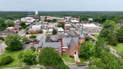 low-aerial-rockingham-nc,-north-carolina-over-church-push-into-skyline