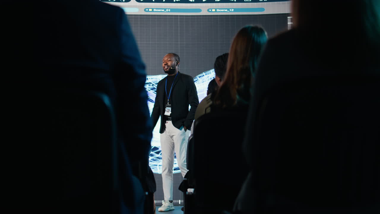 Black male speaker does manufacturing and engineering presentation
