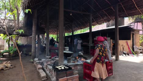 local women are cooking traditional sri lankan food over an open fire in a village kitchen