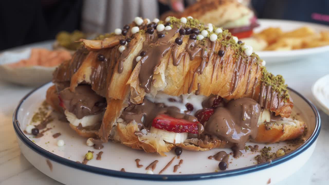 Croissant dessert with chocolate, strawberries, and banana