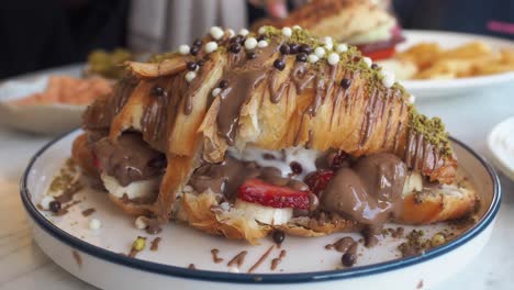 croissant dessert with chocolate, strawberries, and banana