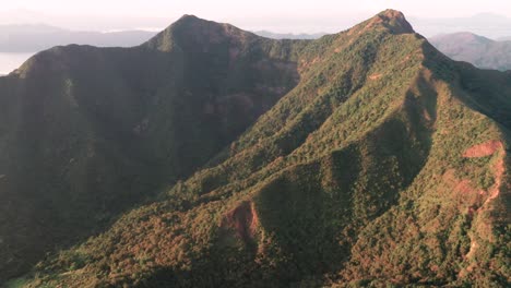 aerial tilt up reveals ma on shan mountains hong kong on cloudy day