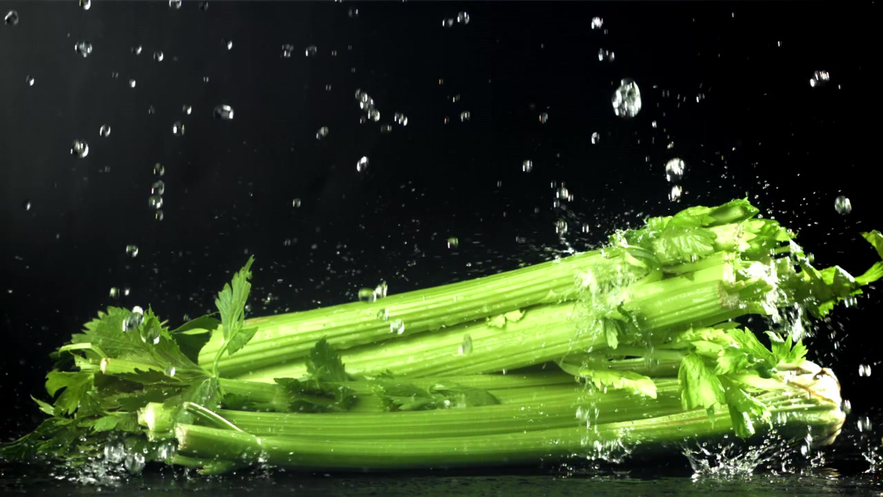 Water Splashing on Fresh Green Celery Stalks