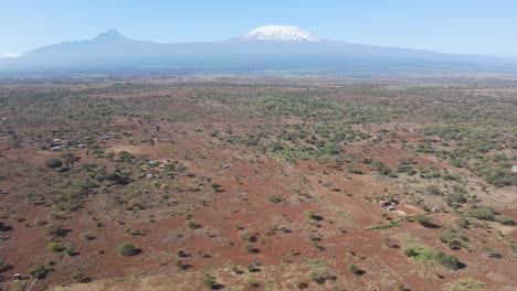 traditional masai farms on savanna at footstep of mount kilimanjaro, aerial view