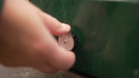 close-up hand turning on a propane camp stove