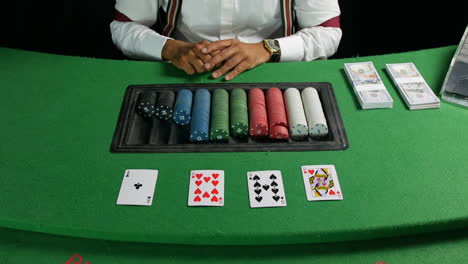 croupier dealer dealing an ace card in a poker game at a casino