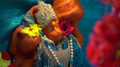 Close-Up-Of-Statue-Of-Hindu-God-Hanuman-Ji-Covered-In-Sindoor-Powder-At-Havan-For-Ceremony-For-Navratri