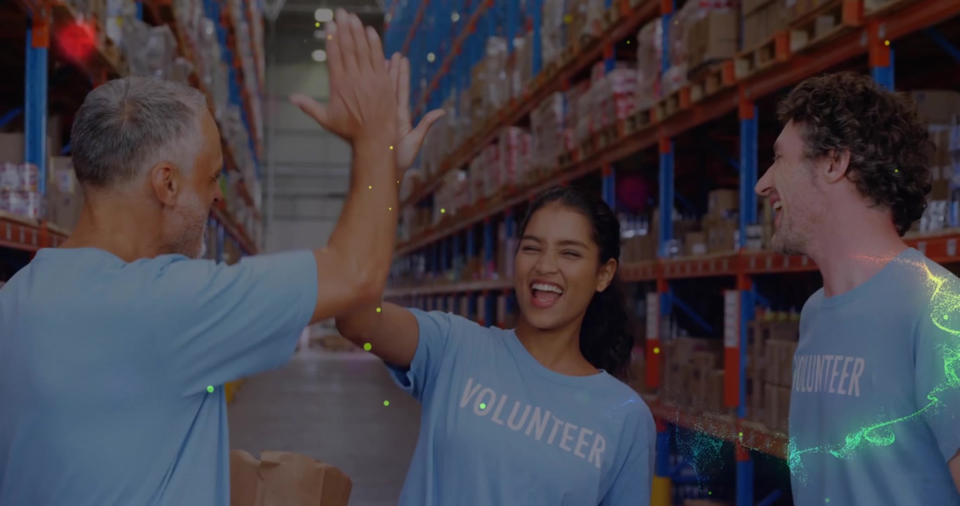 Animation of glowing spots of light over diverse people working in warehouse,