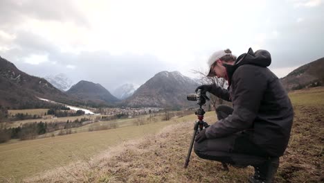 photographer setting up a camera to capture photos during a storm in slovenia