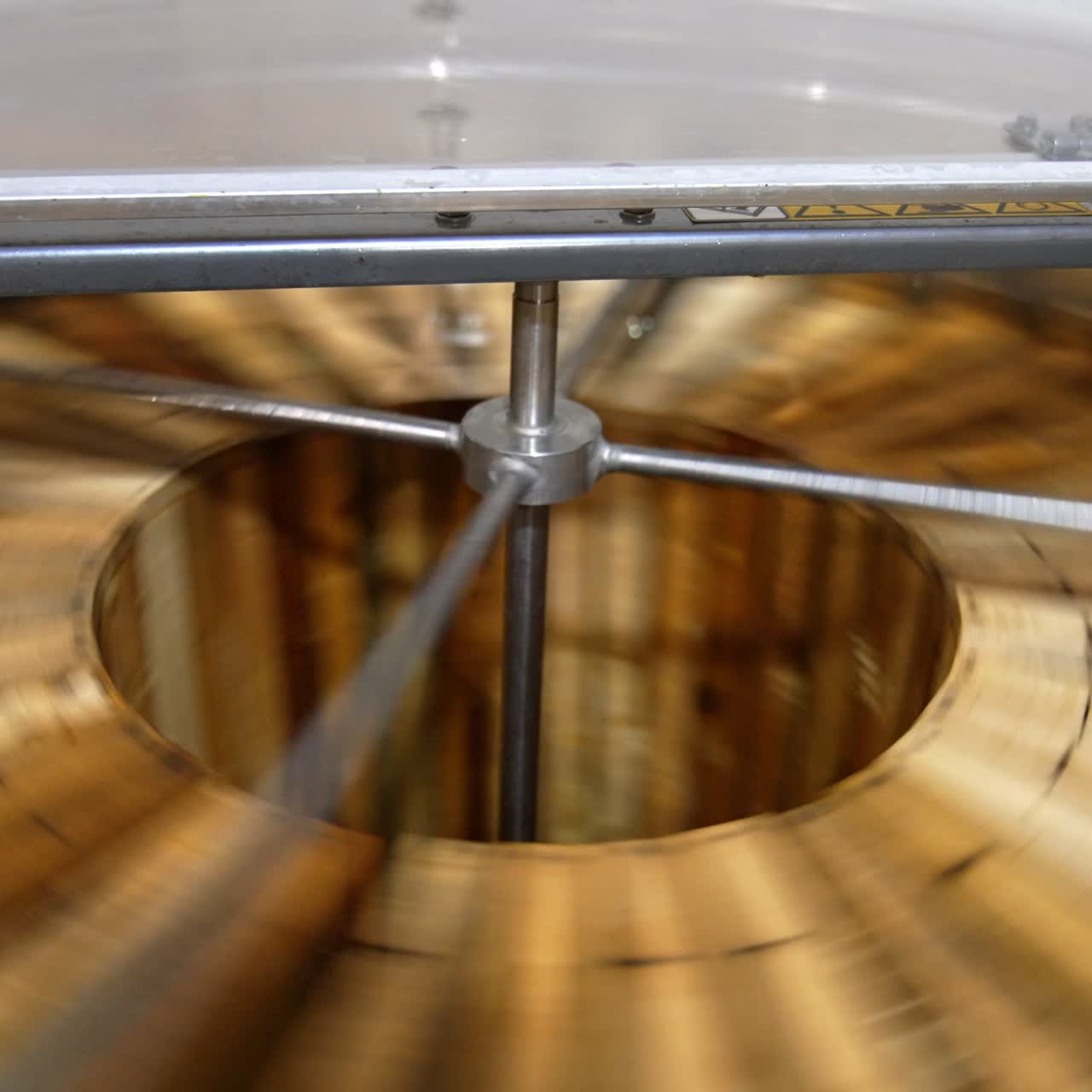 Electric machine for honey removal rotating frames. Close up. Honey extractor working with opened lid. Top view