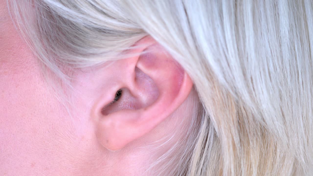 Close up on woman ear. Hearing issue concept
