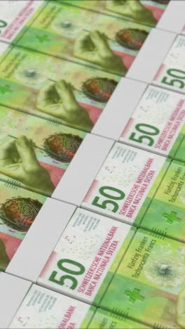 vertical video of 50 swiss franc banknotes printing by a money press