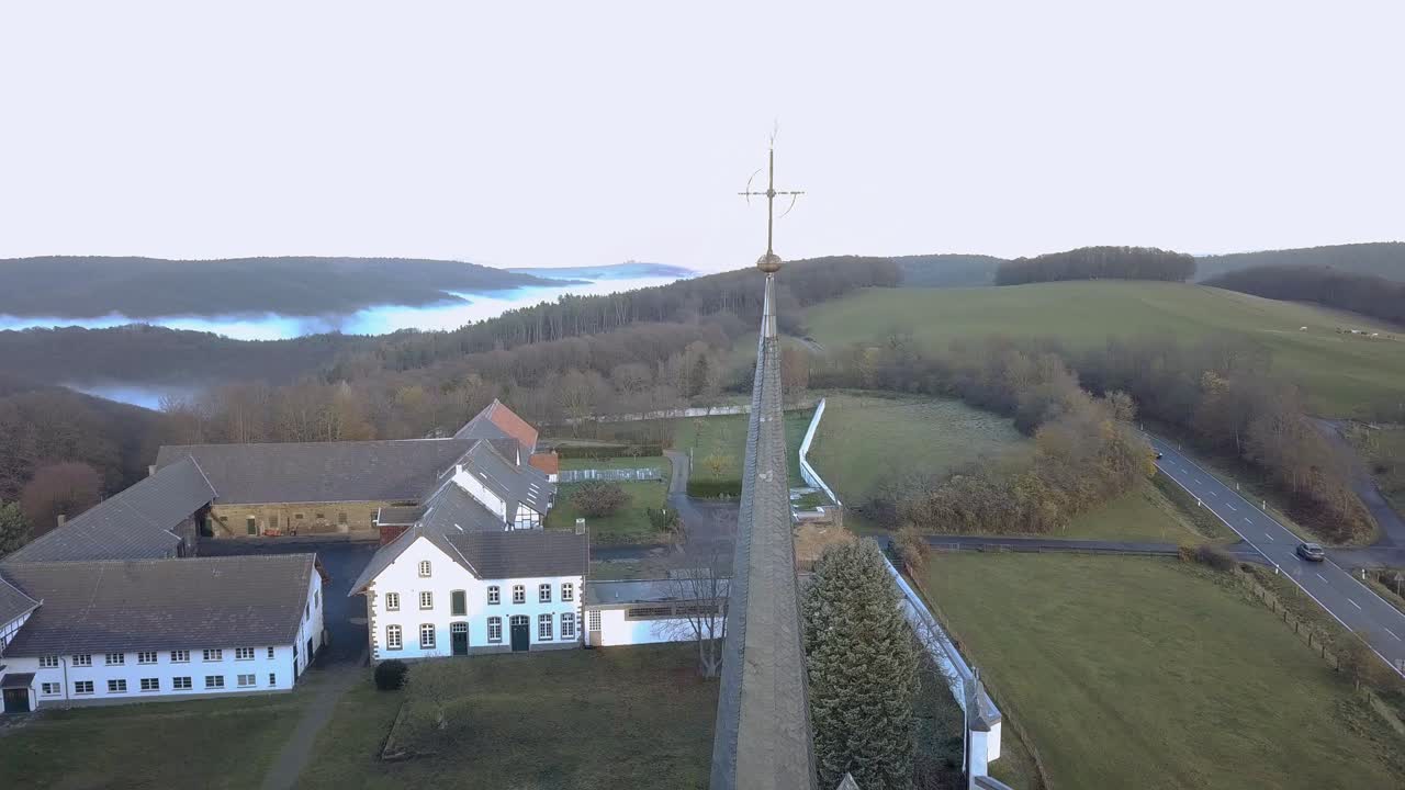 Top of the tower of the German monastery Mariawald Abbey, top view orbit, AERIAL VIEW