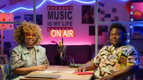 two radio hosts in a studio