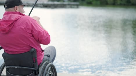 person with a physical disability who uses wheelchair fishing from fishing pier