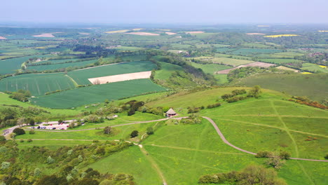 Aerial-wide-flying-away-Butser-Hill-Sunny-day-UK-4K