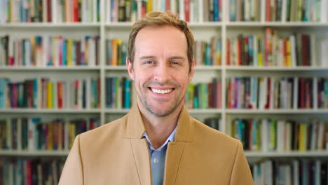 lecturer standing in library in front of bookshelf