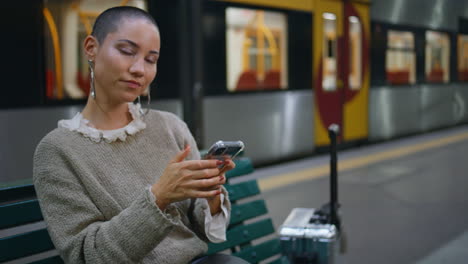 woman using phone at train station