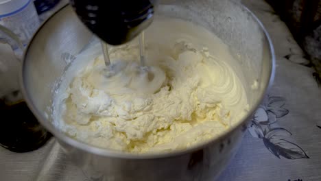 cream being whisked by machine on kitchen table