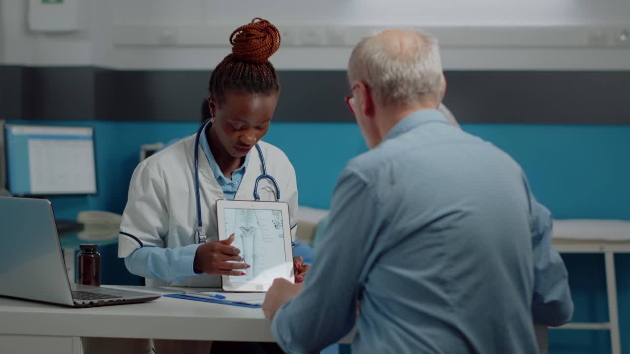 Doctor and Patient Discussing X-ray Results