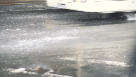 car tyres driving over deep pond and splashing water in slow motion